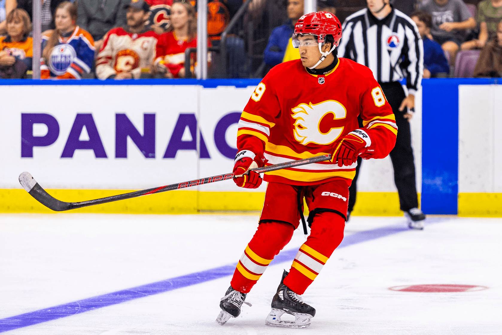 Zayne Parekh skates in the neutral zone in the Calgary Flames vs. Edmonton Oilers game at the 2024 Young Stars Classic in Penticton, BC.