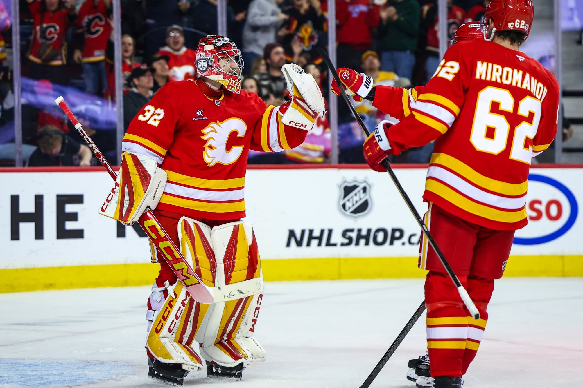 Calgary Flames goaltender Dustin Wolf (32) celebrate win with teammates after defeating Nashville Predators at Scotiabank Saddledome.