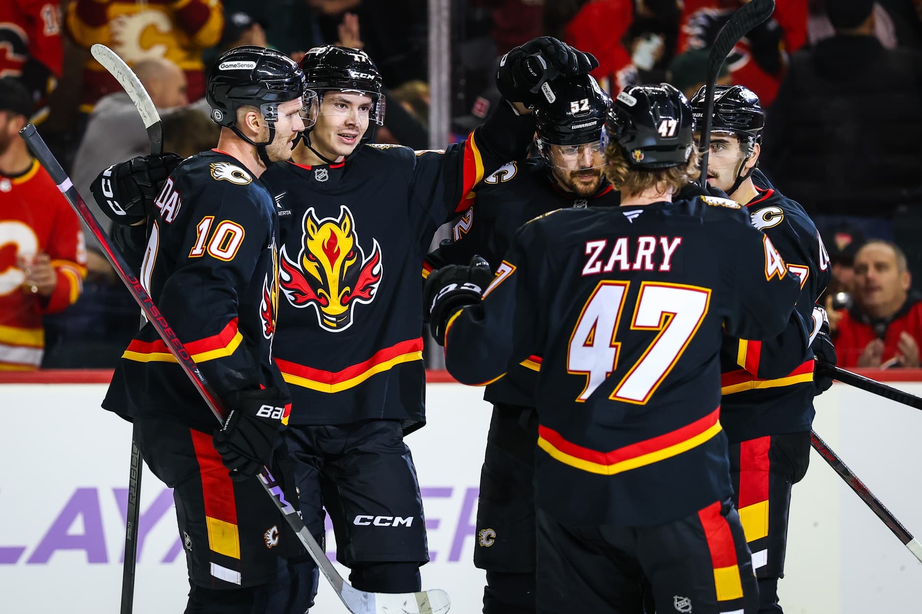 Calgary Flames center Yegor Sharangovich (17) celebrates his goal with teammates against the New York Rangers during the second period at Scotiabank Saddledome