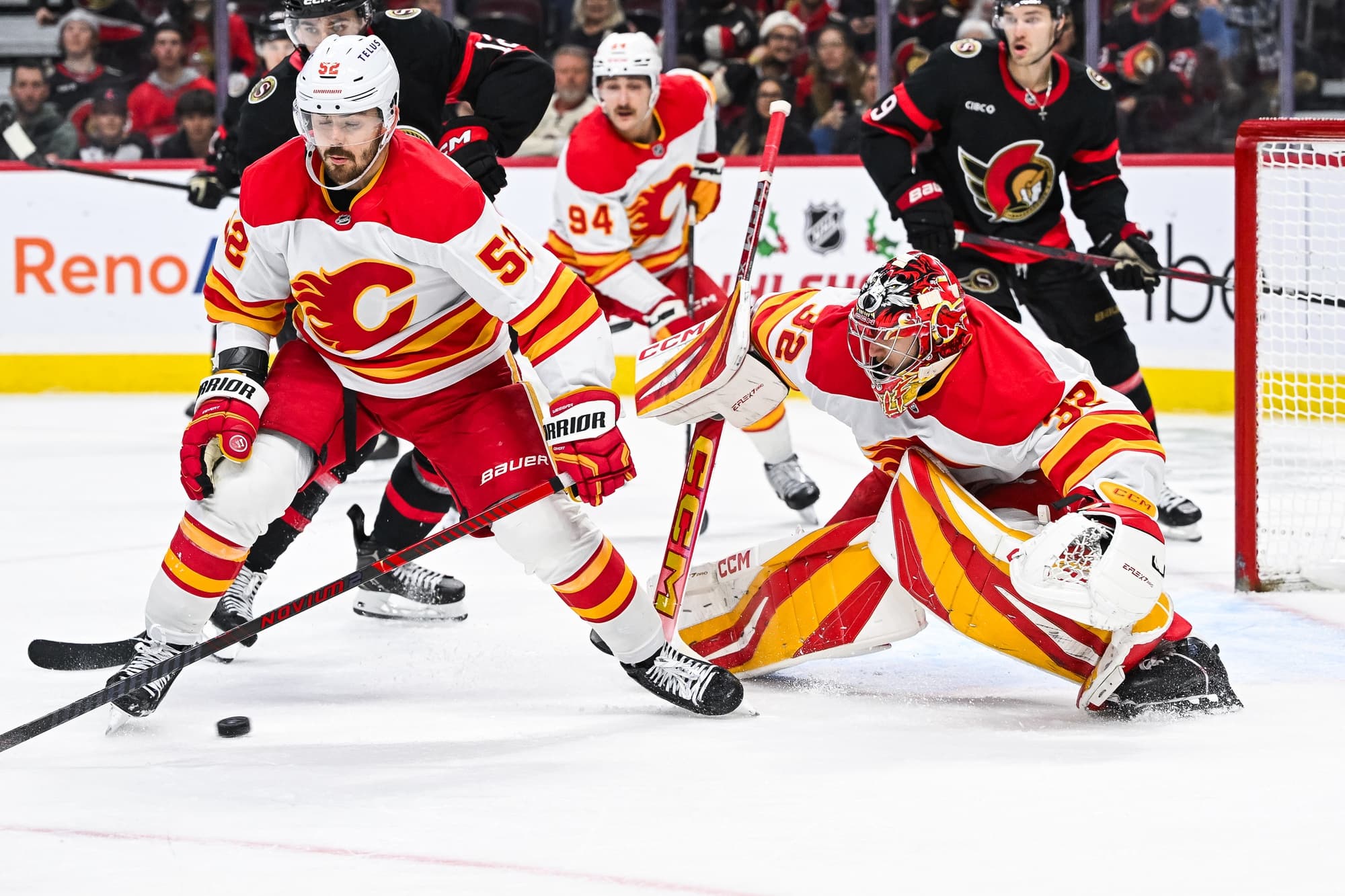 Calgary Flames goalie Dustin Wolf (32) tracks the puck against the Ottawa Senators during the third period at Canadian Tire Centre