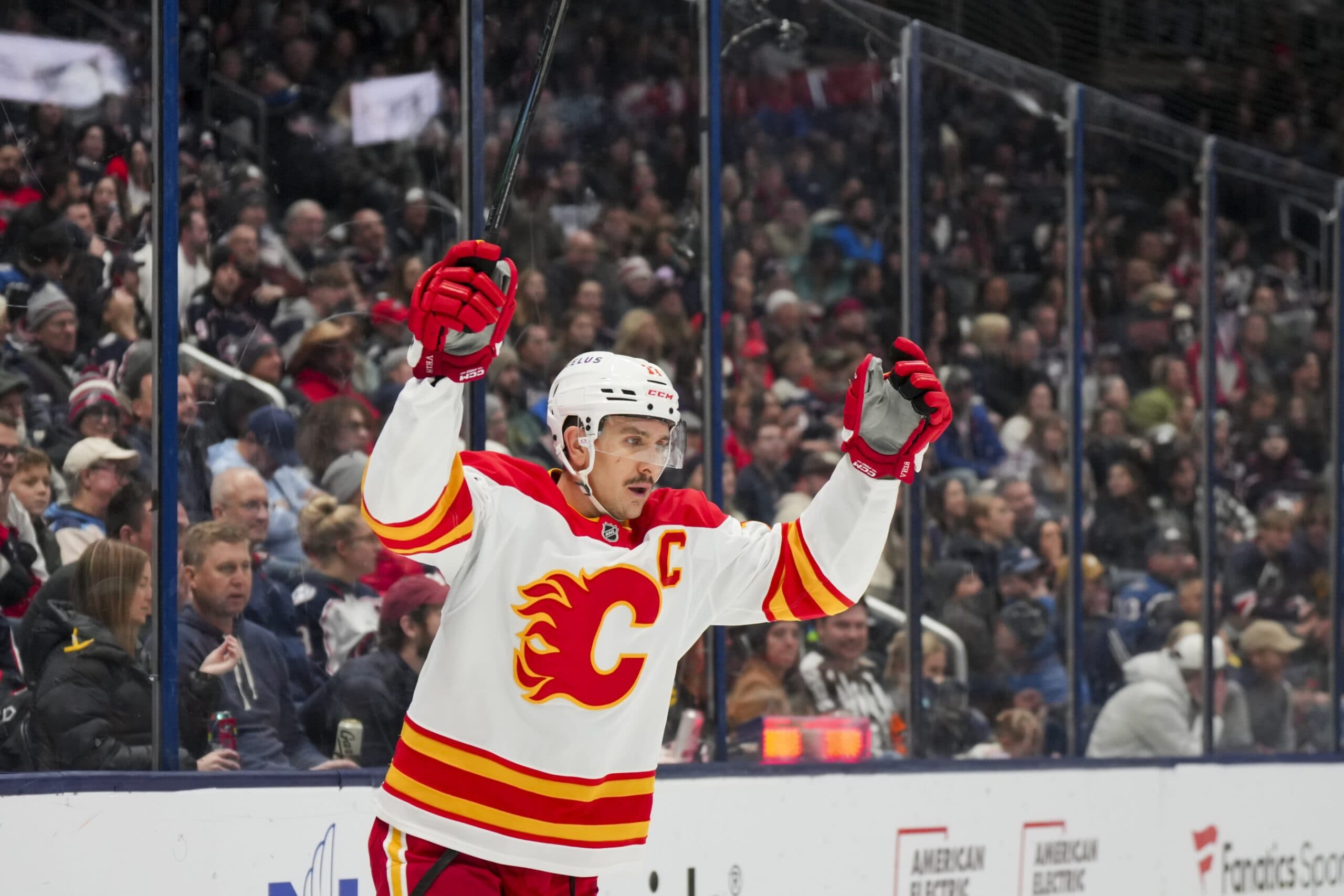 Calgary Flames center Mikael Backlund (11) celebrates the goal scored by center Nazem Kadri (91) in the game against the Columbus Blue Jackets in the third period at Nationwide Arena.