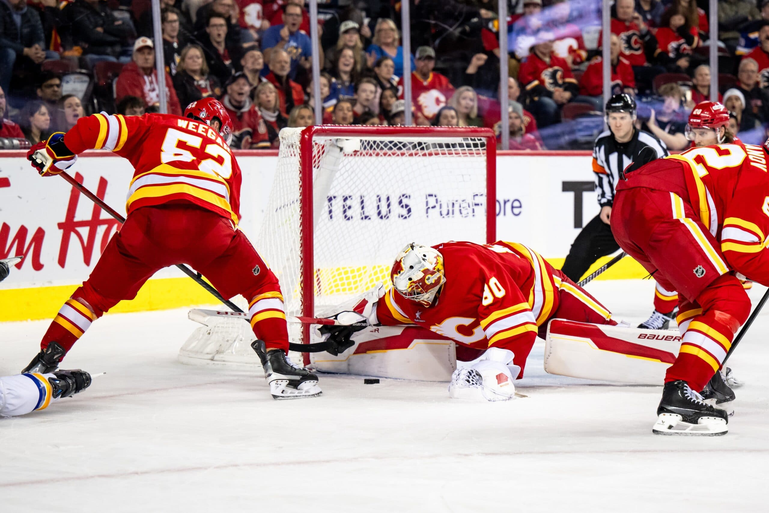 Calgary Flames goaltender Daniel Vladar (80) covers the puck after stopping a St. Louis Blues shot during the third period at Scotiabank Saddledome.