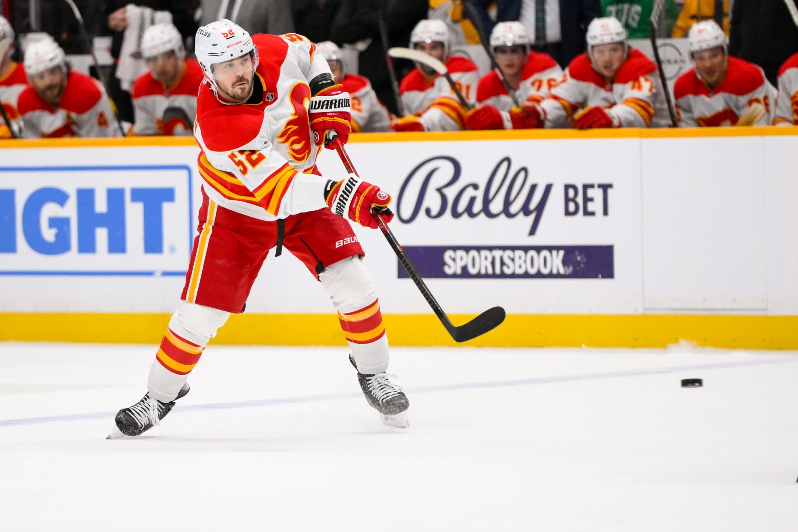 Calgary Flames defenseman MacKenzie Weegar (52) takes a shot on goal against the Nashville Predators during the second period at Bridgestone Arena.