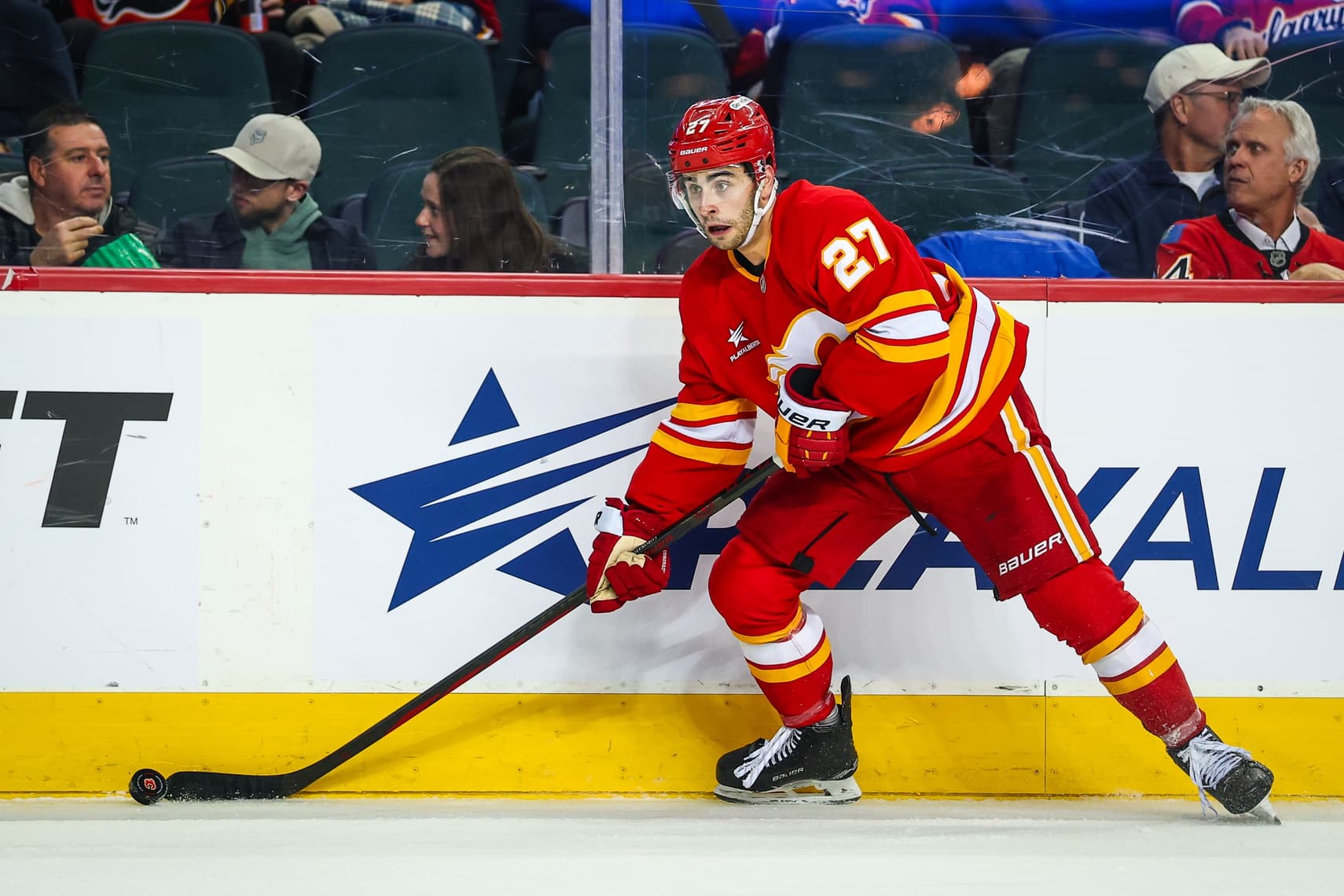 Calgary Flames right wing Matt Coronato (27) controls the puck against the Ottawa Senators during the second period at Scotiabank Saddledome.