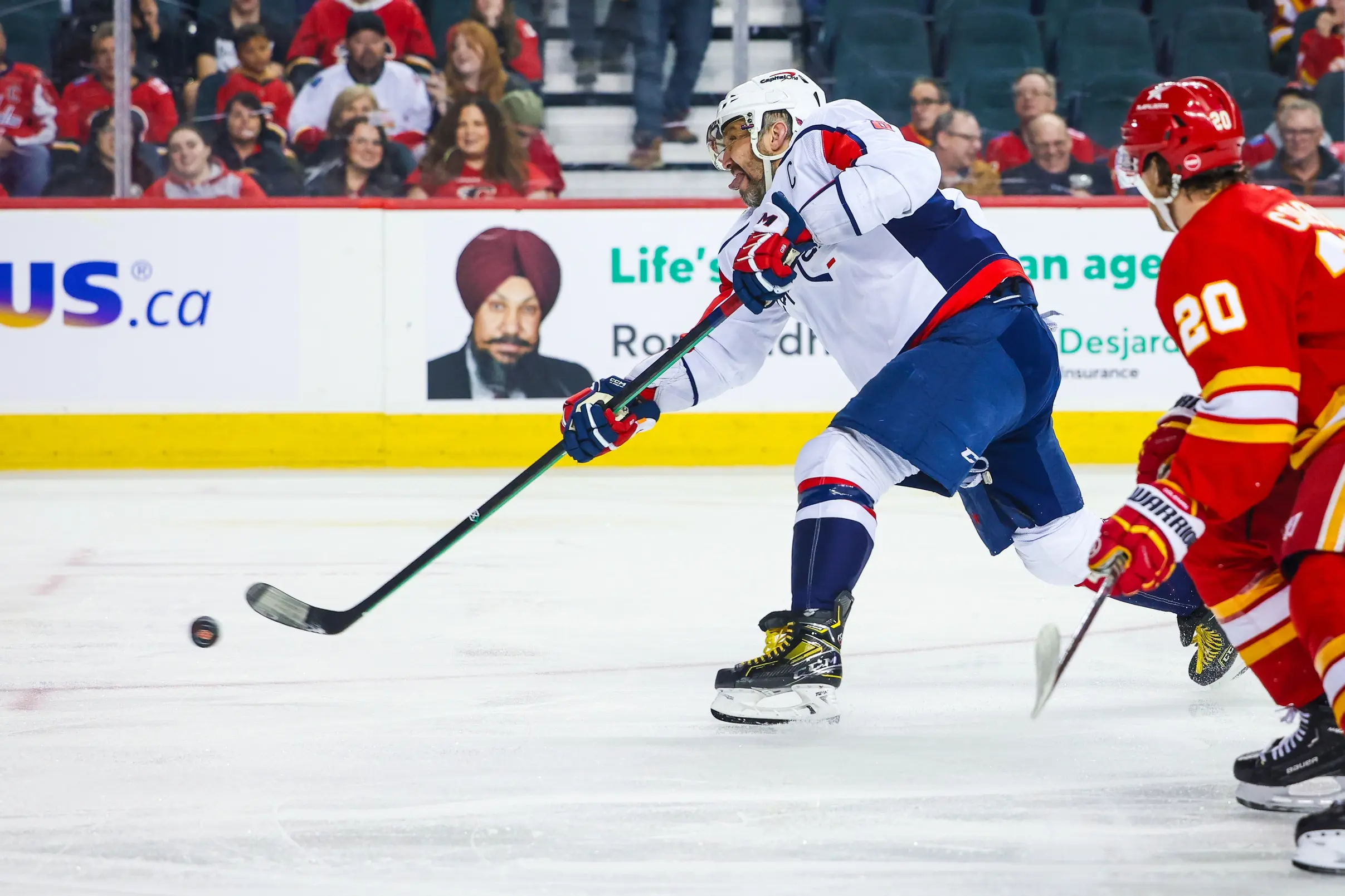 Washington Capitals left wing Alex Ovechkin (8) shoots the puck against the Calgary Flames during the third period at Scotiabank Saddledome.