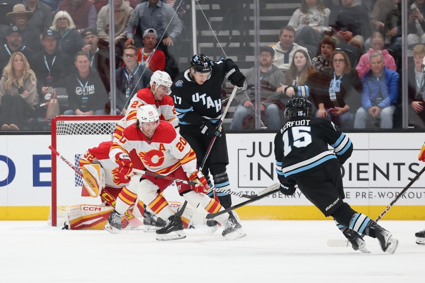 Utah Hockey Club center Alexander Kerfoot (15) shoots and scores against the Calgary Flames during the first period at Delta Center.