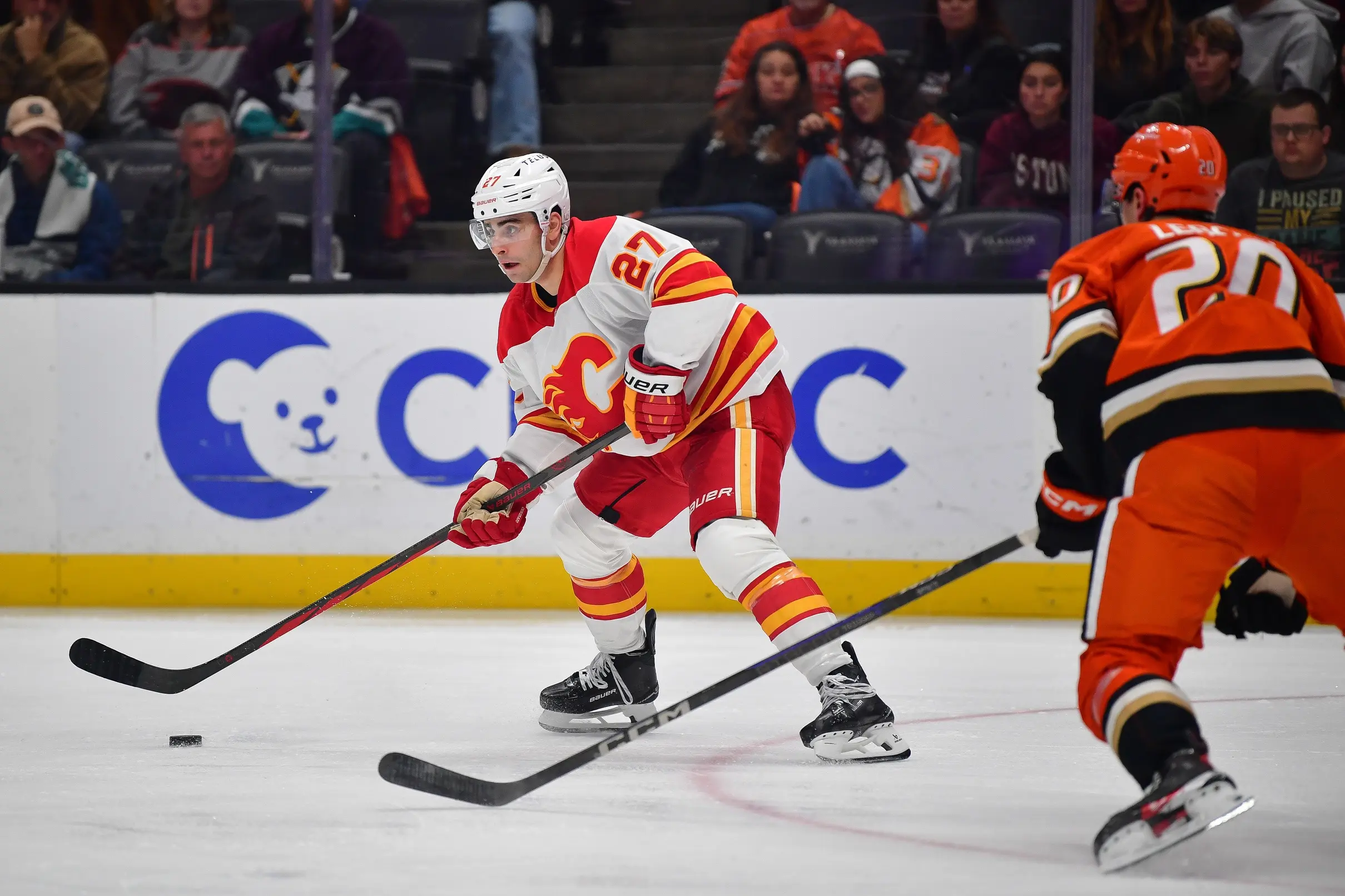 Calgary Flames right wing Matt Coronato (27) moves the puck against Anaheim Ducks right wing Brett Leason (20) during the third period at Honda Center.