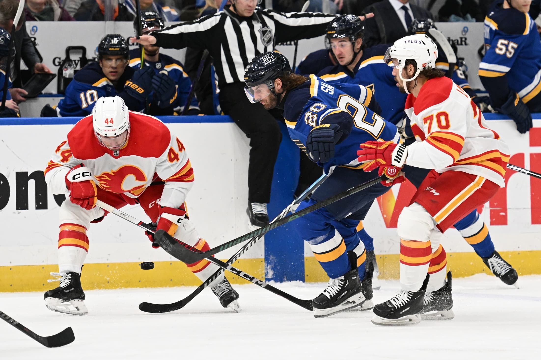 Calgary Flames defenseman Joel Hanley (44) and teammate left wing Ryan Lomberg (70) battle St. Louis Blues left wing Brandon Saad (20) for the puck in the second period at Enterprise Center.