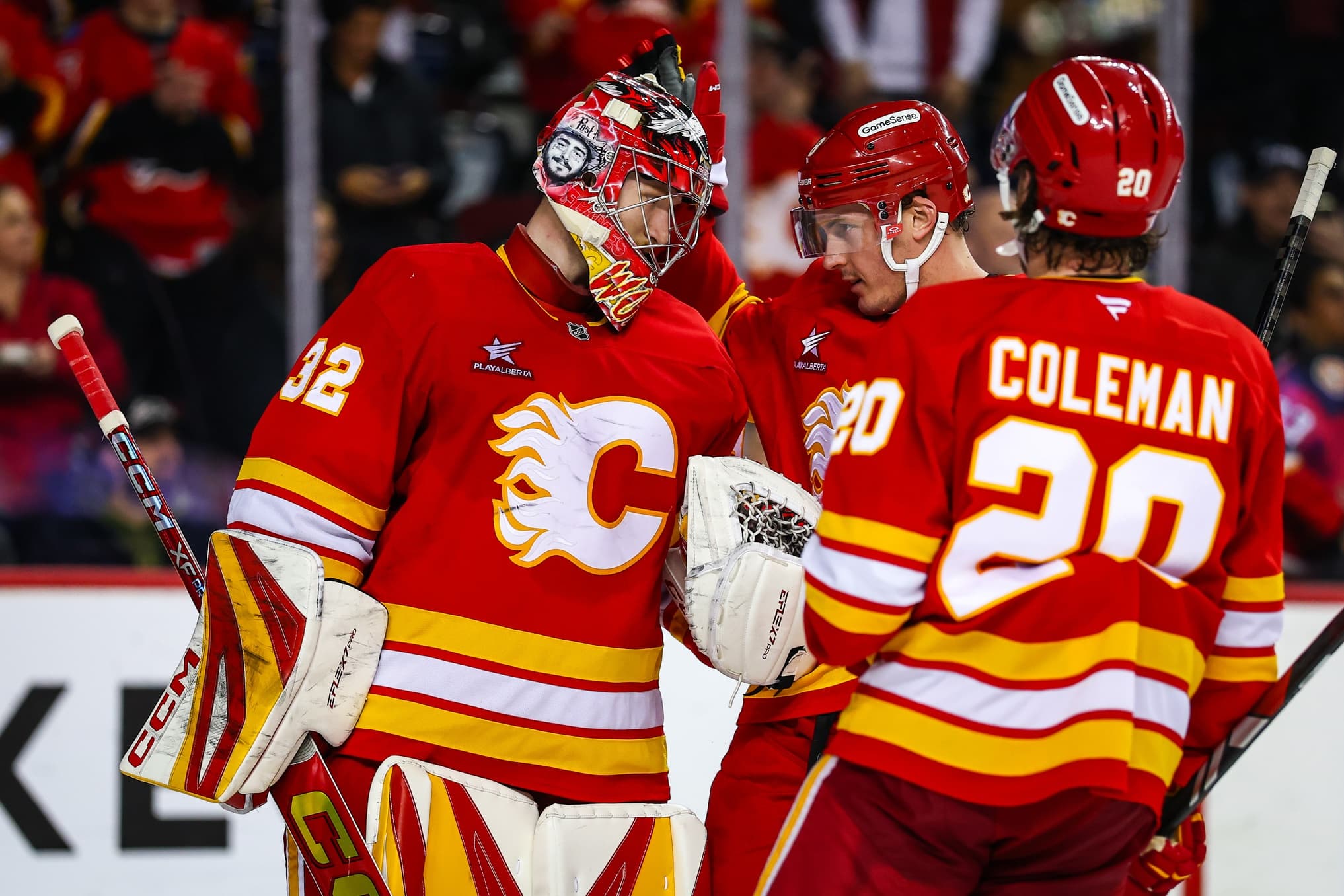 Calgary Flames goaltender Dustin Wolf (32) celebrate win with teammates after defeating the Anaheim Ducks at Scotiabank Saddledome.