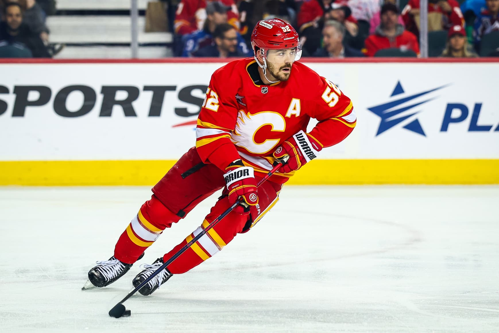 Calgary Flames defenseman MacKenzie Weegar (52) skates with the puck against the Colorado Avalanche during the first period at Scotiabank Saddledome.
