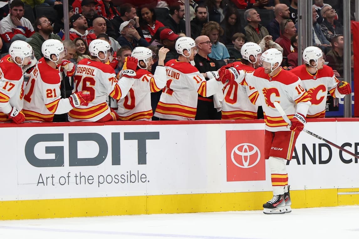 Calgary Flames left wing Jonathan Huberdeau (10) celebrates with teammates after scoring a goal against the Washington Capitals in the third period at Capital One Arena