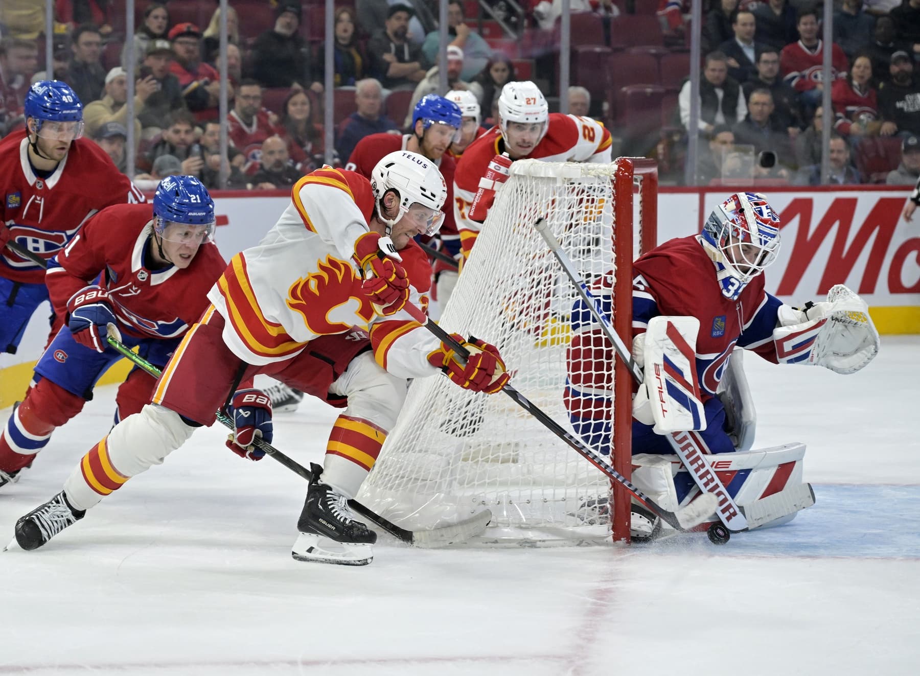 Montreal Canadiens goalie Sam Montembeault (35) stops Calgary Flames forward Blake Coleman (20) during the third period at the Bell Centre.