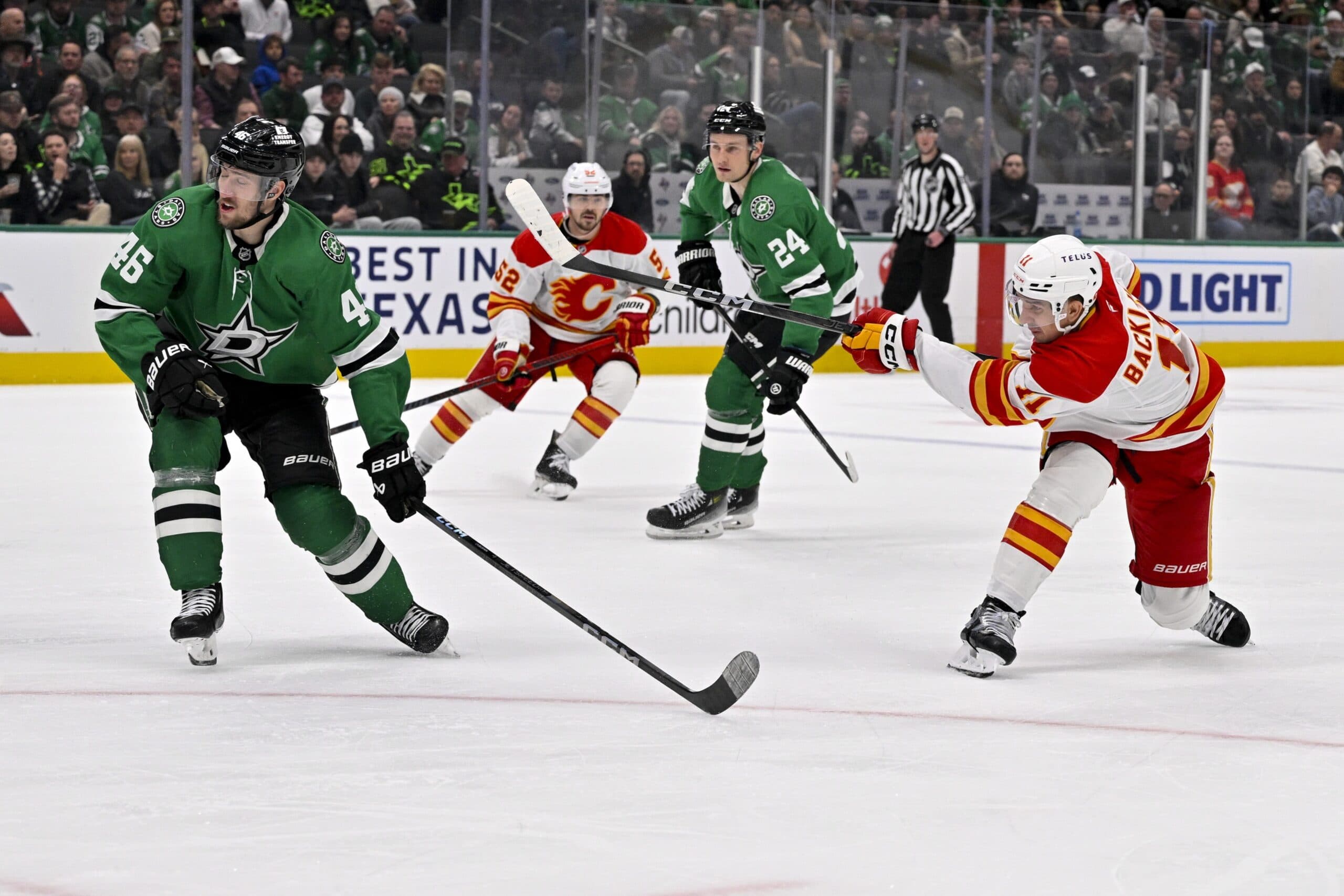 Calgary Flames center Mikael Backlund (11) shoots the puck past Dallas Stars defenseman Ilya Lyubushkin (46) during the third period at the American Airlines Center.