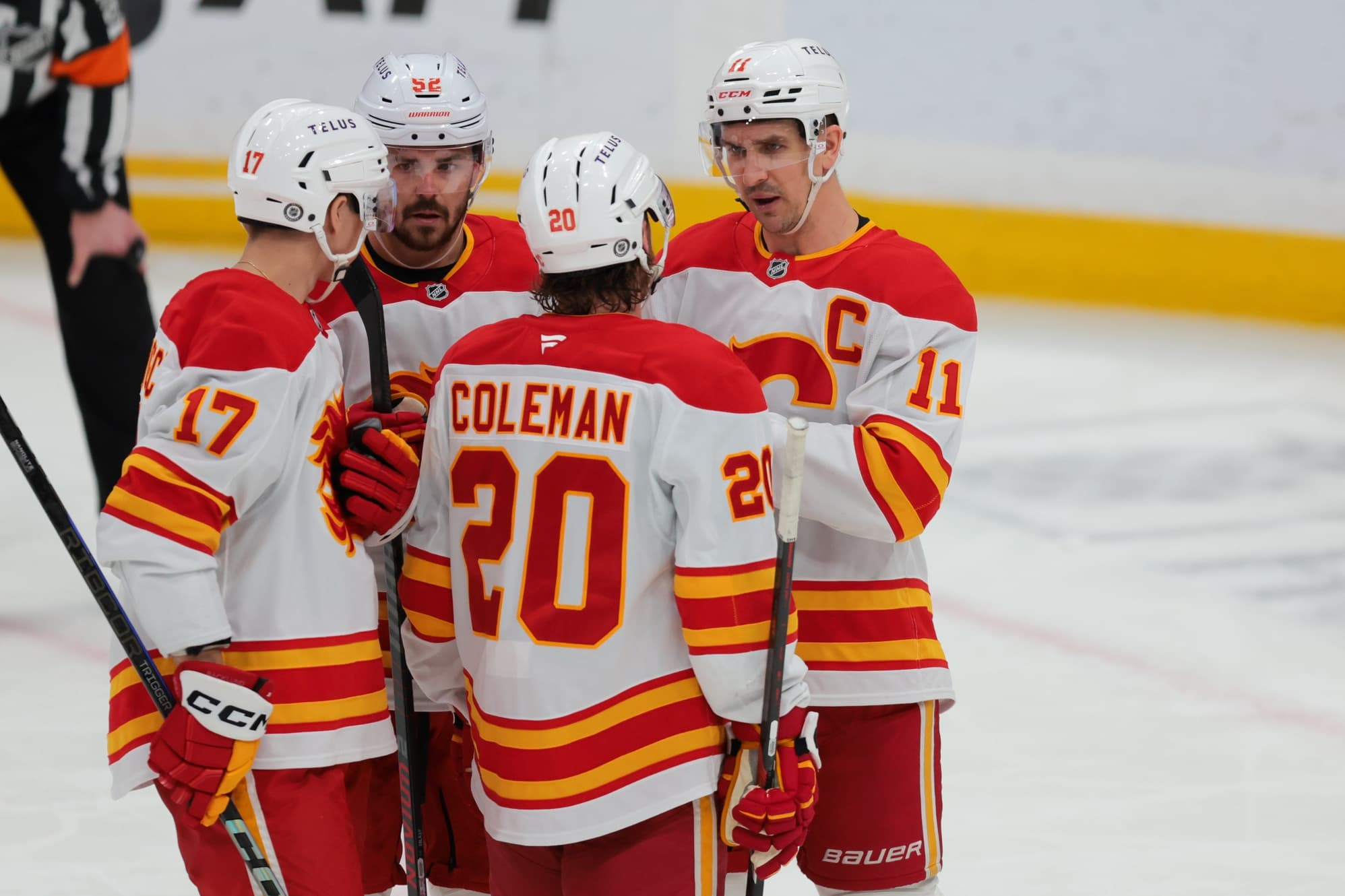 Calgary Flames center Mikael Backlund (11) talks to left wing Blake Coleman (20), center Yegor Sharangovich (17) and defenseman MacKenzie Weegar (52) during the second period against the Florida Panthers at Amerant Bank Arena.