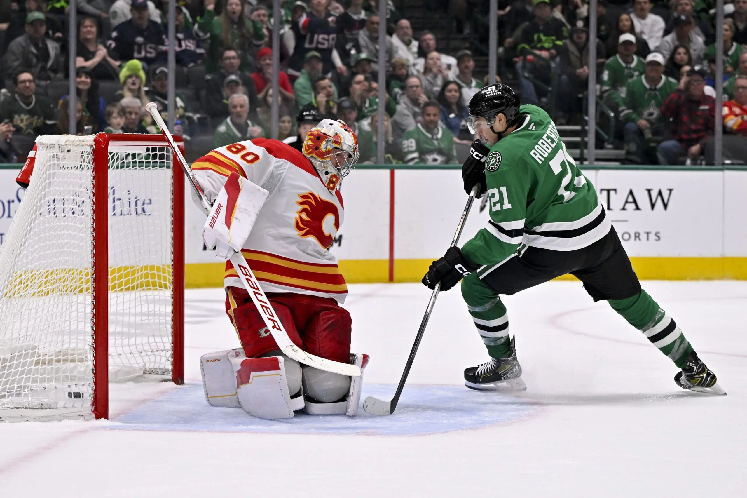 Dallas Stars left wing Jason Robertson (21) scores the game winning goal against Calgary Flames goaltender Dan Vladar (80) during the overtime period at the American Airlines Center.
