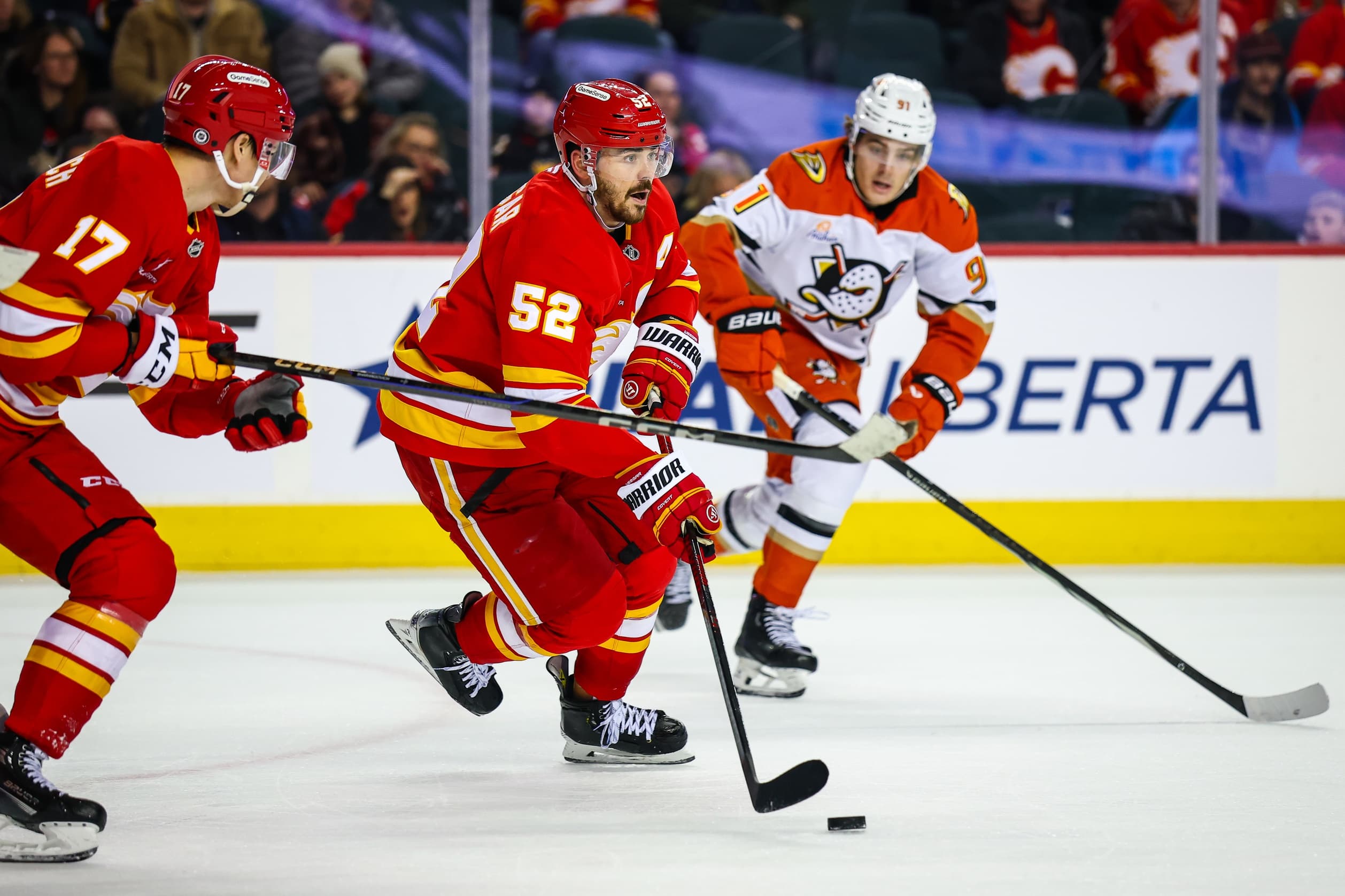 Calgary Flames defenseman MacKenzie Weegar (52) controls the puck against the Anaheim Ducks during the third period at Scotiabank Saddledome
