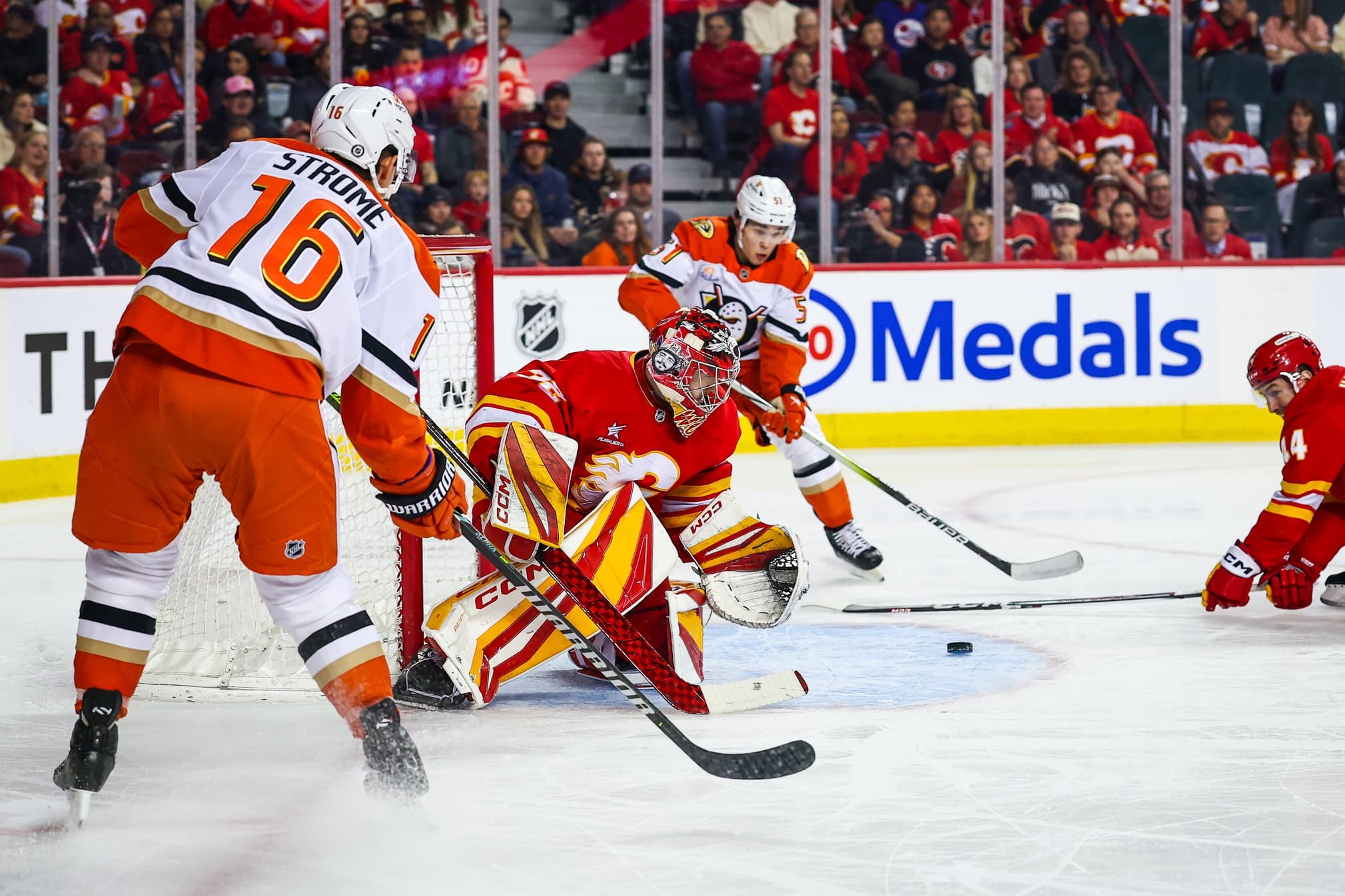 Calgary Flames goaltender Dustin Wolf (32) reacts as Anaheim Ducks defenseman Olen Zellweger (51) scores a goal during the first period at Scotiabank Saddledome